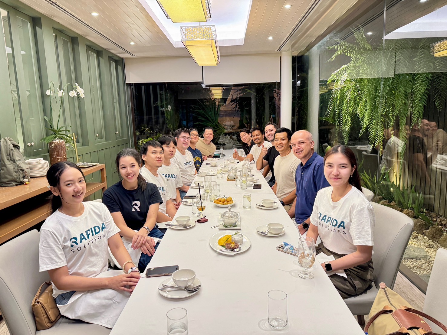 Rapida team dinner in matching Rapida Solutions t-shirts